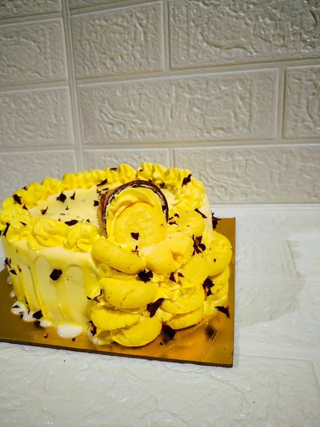 Special Yellow Cream Cake — custom cake by Sweet Bites Goa