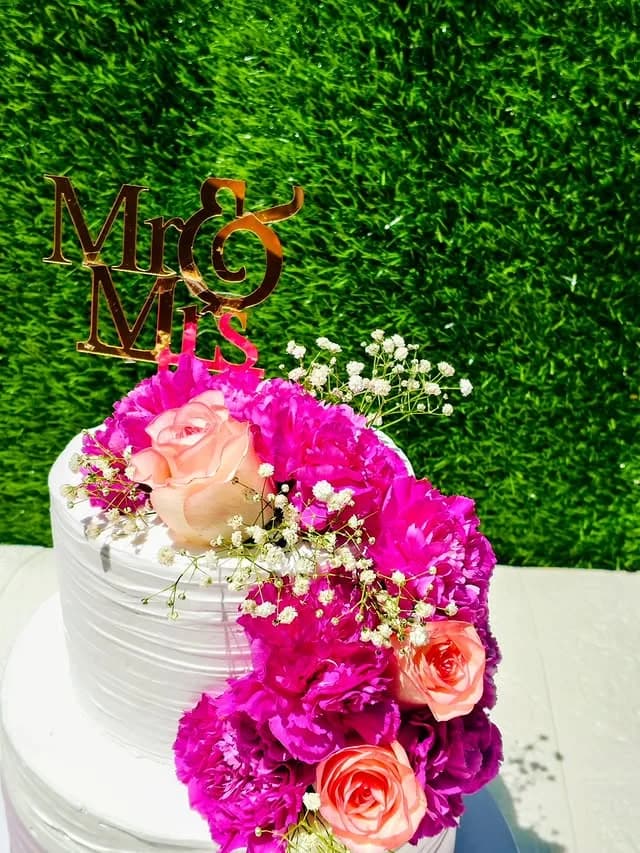Wedding cake Goa — three-tier white reception cake by Sweet Bites Muskan